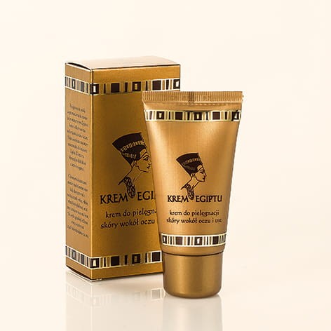 Krem do oczu i ust 30 ml serii "Egipt" firmy Korana. Plastikowa tubka w kolorze miedzianym z grafiką "Nefretete" oraz niezbędnymi informacjami produkcie. Po lewej stronie kartonowe opakowanie w tym samym stylu do którego pakowana jest tubka.