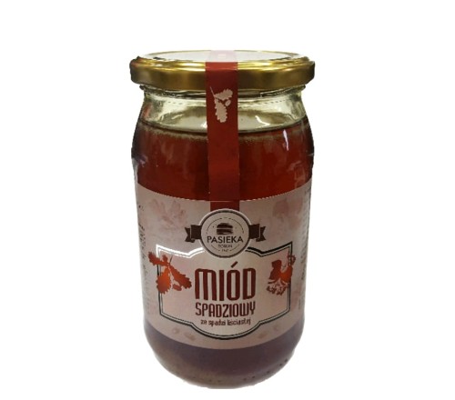 Miód spadziowy 0,6 kg - Pasieka. Przezroczysty słoik z ciemną zawartością oraz złotą zakrętką. Etykieta jest w kolorze jasnym z liśćmi. Etykieta zawiera logo, nazwę, producenta, pojemność oraz skład.