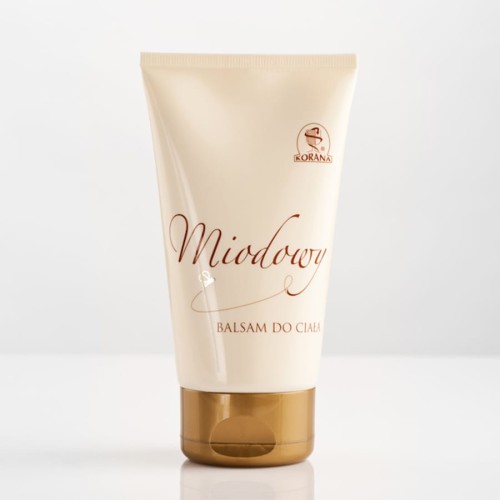 Balsam do ciała 200ml z serii miodowej z Korany. Balsam jest w plastikowej tubce w kolorze kremowym ze złotą zatyczką oraz brązowymi informacjami na opakowaniu.