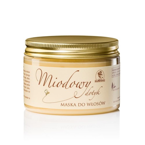 Miodowa maska do włosów w plastikowym opakowaniu o pojemności 150 ml. Maska jest w kolorze żółtym z beżową etykietą z niezbędnymi informacjami o produkcie. Zakrętka jest w kolorze złotym.