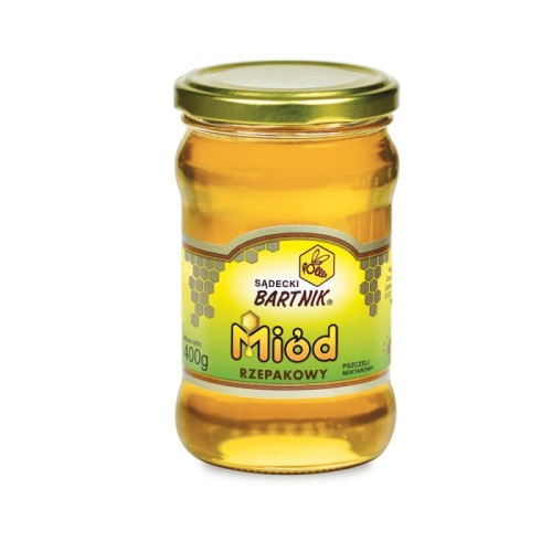 Miód Rzepakowy 400 g - Sądecki Bartnik. Przezroczysty słoik z żółtą zawartością, zielono- żółta etykieta  ze złotymi komórkami pszczelimi  zawierająca: logo, nazwę , producenta, pojemność oraz skład. Złota zakrętka.