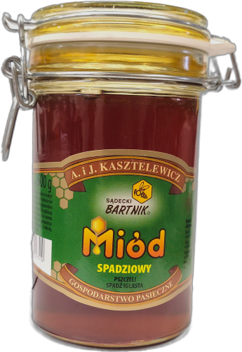 Miód Gryczany Komfort- Sądecki Bartnik  o pojemności 0,6 kg. Jasno brązowy miód w przezroczystym słoiku z pokrywką zamykaną na klamrę. Słoik posiada zieloną etykietę, na której są podstawowe informacje: nazwa, producent, waga, kraj.