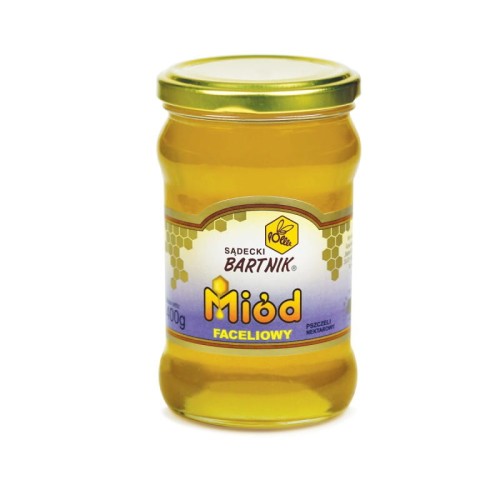 Miód faceliowy - 400 g Sądecki Bartnik. Przezroczysty słoik z jasno żółtym miodem złota nakrętką oraz  etykietą "Miód Faceliowy", pszczeli nektarowy . Napisy w żółtym kolorze z czarną obramówką .