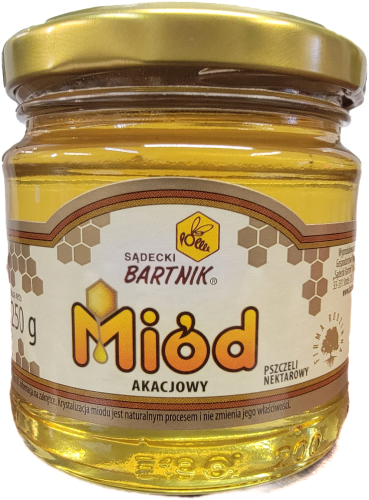 Miód akacjowy - 250 g Sądecki Bartnik. Przezroczysty słoik z jasno żółtym miodem złota nakrętką oraz  etykietą " Miód Akacjowy, nektar pszczeli" . Napisy w żółtym kolorze z czarną obramówką.