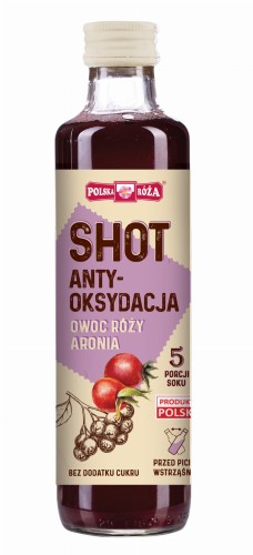 Polska Róża- Shot Antyoksydacyjna. Produkt zawiera wyciąg z :owoców róży oraz aronii. Nie zawiera cukrów. Butelka 250 ml. Etykieta w beżowo, fioletowej tonacji. Napisy w kolorze brązowym i biały. Zdjęcia owoców na etykiecie.